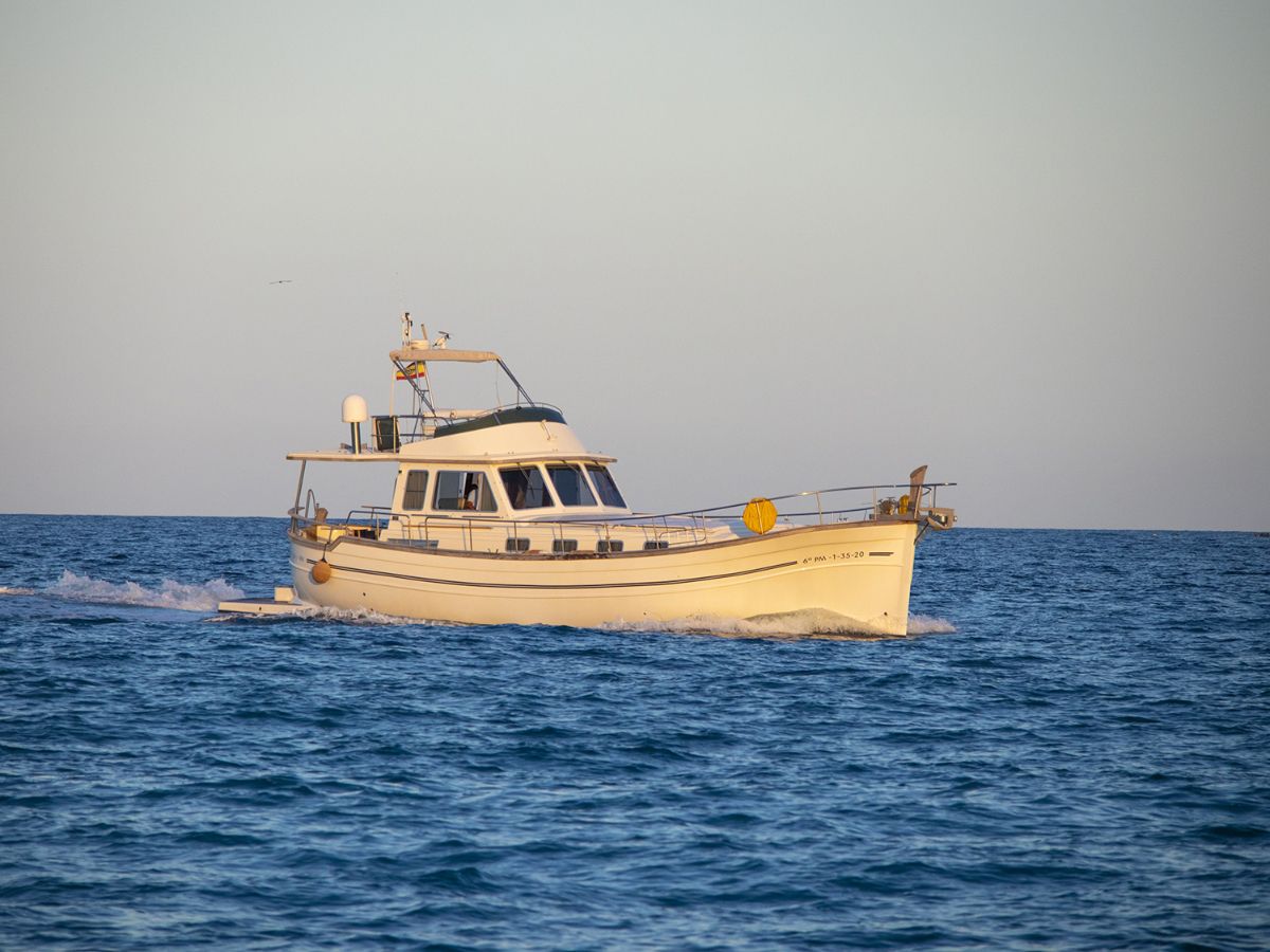 Private boat charter Ibiza — luxury yacht with skipper on open water